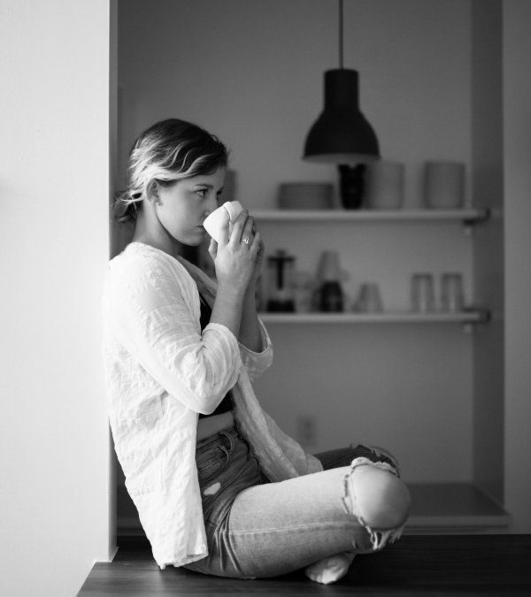 Woman sniffing aroma of black tea in her cup, photo by Nik MacMillan on Unsplash